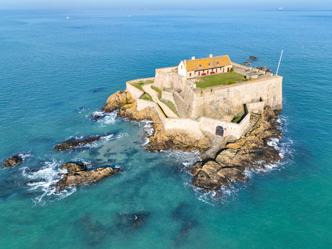Aerial view of golden stone fort standing defiant against the turquoise sea a beacon of history amidst the rugged rocks Fort National Saint Malo Brittany France. Aerial view of golden stone fort standing defiant against the turquoise sea a beacon of history amidst the rugged rocks Fort National Saint Malo Brittany France.