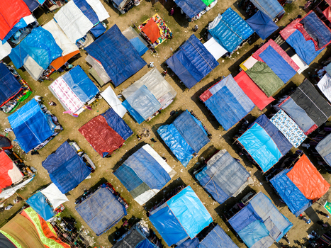 Aerial view of a vibrant tapestry of colorful tents creating a patchwork effect across the landscape Charmonai Barisal Division Bangladesh. Aerial view of a vibrant tapestry of colorful tents creating a patchwork effect across the landscape Charmonai Barisal Division Bangladesh.
