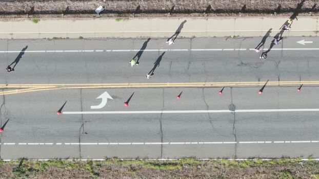 Aerial view of people walking on a road in United States. Aerial view of people walking on a road in United States.