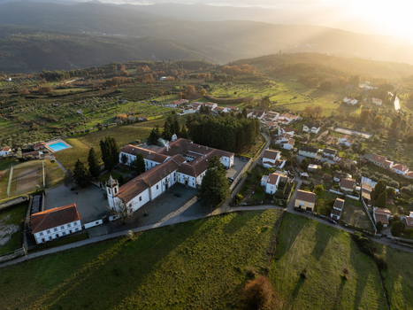Vila Pouca da Beira Portugal 31 December 2023 Aerial view of the Lam Hotel Convento do Desagravo surrounded by green fields and rolling hills under a warm golden sunset light. Vila Pouca da Beira Portugal 31 December 2023 Aerial view of the Lam Hotel Convento do Desagravo surrounded by green fields and rolling hills under a warm golden sunset light.
