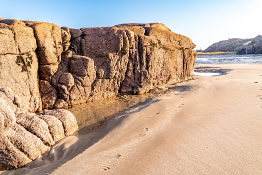 View of large granite rock formations on the sandy beach at Cloughglass County Donegal Ireland. View of large granite rock formations on the sandy beach at Cloughglass County Donegal Ireland.