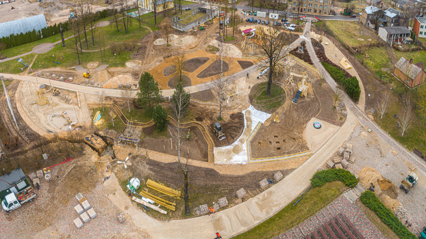 Aerial view of a park construction site with new playground equipment dirt paths and landscaping work in progress in Latvia. Aerial view of a park construction site with new playground equipment dirt paths and landscaping work in progress in Latvia.