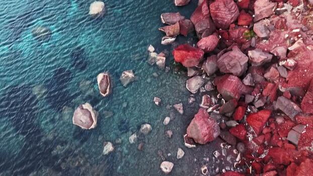 Aerial view of Red beach with volcanic rocks and blue sea Greece.