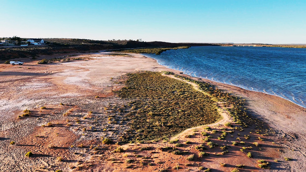 Aerial view of Matthew Flinders Red Cliff Lookout featuring rugged red cliffs coastal vegetation and the blue waters of the Spencer Gulf in Port Augusta West South Australia Australia. Aerial view of Matthew Flinders Red Cliff Lookout featuring rugged red cliffs coastal vegetation and the blue waters of the Spencer Gulf in Port Augusta West South Australia Australia.