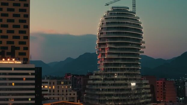 Aerial view of a modern illuminated skyscraper at dusk Albania. Aerial view of a modern illuminated skyscraper at dusk Albania.
