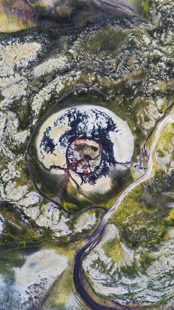 Aerial view of a volcanic crater Stutur with dark lava flows and vibrant green mossy terrain in Iceland. Aerial view of a volcanic crater Stutur with dark lava flows and vibrant green mossy terrain in Iceland.