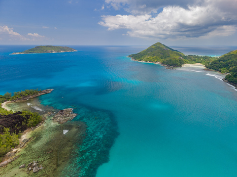 Aerial view of turquoise waters meet verdant islands under a vast sky showcasing the natural beauty of the Seychelles Victoria Mahe Island Seychelles. Aerial view of turquoise waters meet verdant islands under a vast sky showcasing the natural beauty of the Seychelles Victoria Mahe Island Seychelles.