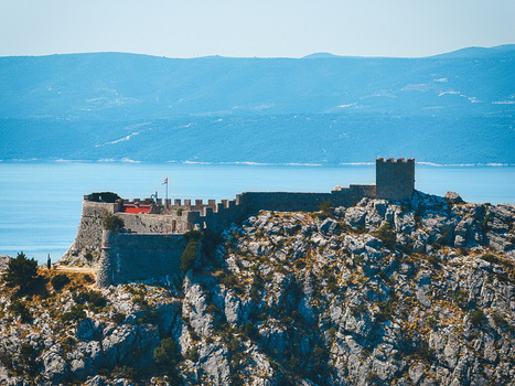 Aerial view of Starigrad Fortress on a rocky hill overlooking the Adriatic Sea in Omis Split Dalmatia County Croatia. Aerial view of Starigrad Fortress on a rocky hill overlooking the Adriatic Sea in Omis Split Dalmatia County Croatia.