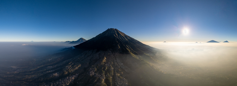 Aerial view of Nepal Van Java on the slopes of Mount Sumbing featuring terraced agricultural fields and morning mist Kecamatan Kaliangkrik Jawa Tengah Indonesia.