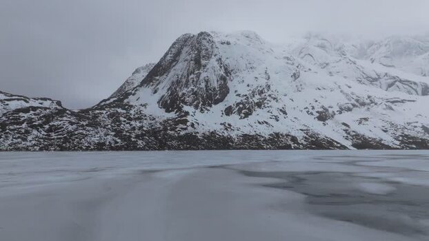 Aerial view of Lofoten mountains and frozen lake Norway.