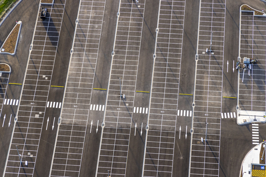 Melbourne Airport Australia 01 May 2026 Aerial view of Value Short and Long Stay Car Park featuring empty parking bays white road markings and pedestrian crossings.