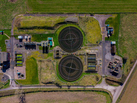 Aerial view of Gnosall Heath sewage treatment plant with circular sedimentation tanks filtration basins and surrounding green fields in Gnosall England United Kingdom. Aerial view of Gnosall Heath sewage treatment plant with circular sedimentation tanks filtration basins and surrounding green fields in Gnosall England United Kingdom.