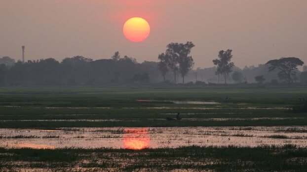 View of a sunset over rural wetlands in Bogura Bangladesh.