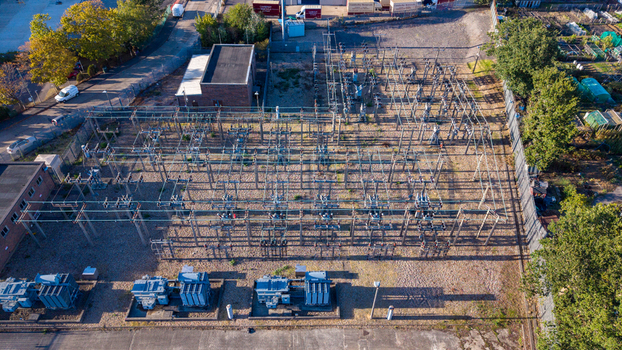 Aerial view of an electricity sub station with industrial transformers and electrical infrastructure in a fenced compound in Camberley England United Kingdom. Aerial view of an electricity sub station with industrial transformers and electrical infrastructure in a fenced compound in Camberley England United Kingdom.