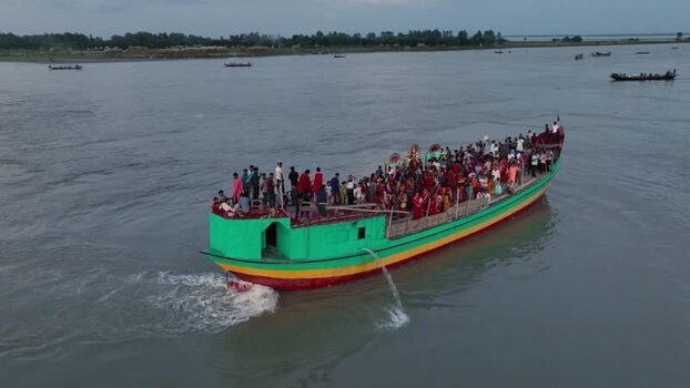 Aerial view of a crowded colorful boat on the Jamuna River Bangladesh.