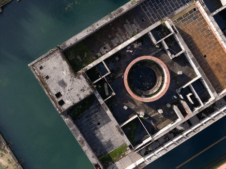 Aerial view of the abandoned foundations of the Zarnowiec Nuclear Power Plant a Cold War era project featuring a prominent circular concrete structure and weathered rooftops Zarnowiec Poland. Aerial view of the abandoned foundations of the Zarnowiec Nuclear Power Plant a Cold War era project featuring a prominent circular concrete structure and weathered rooftops Zarnowiec Poland.