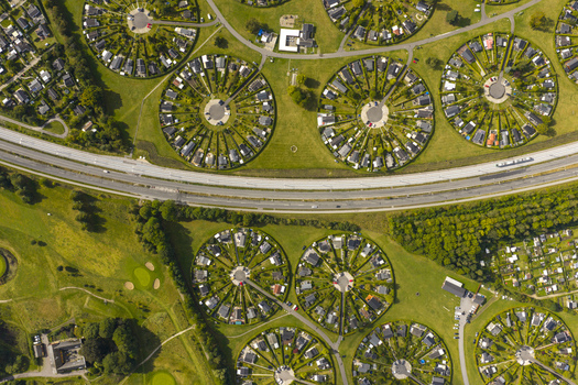 Aerial view of Haveforeningen Harekaer circular garden community with unique circular housing layouts and green hedges under bright sunlight in Brondby Denmark. Aerial view of Haveforeningen Harekaer circular garden community with unique circular housing layouts and green hedges under bright sunlight in Brondby Denmark.