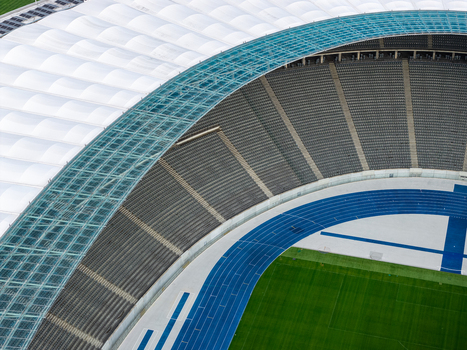 Berlin Germany 26 September 2026 Aerial view of Olympiastadion Berlin showcasing the iconic blue running track green field and the distinctive curved roof structure.