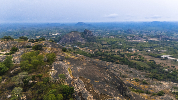 Aerial view of rocky outcrops and lush greenery blend under a vast sky highlighting the natural beauty of the landscape Oyo Oyo Nigeria. Aerial view of rocky outcrops and lush greenery blend under a vast sky highlighting the natural beauty of the landscape Oyo Oyo Nigeria.