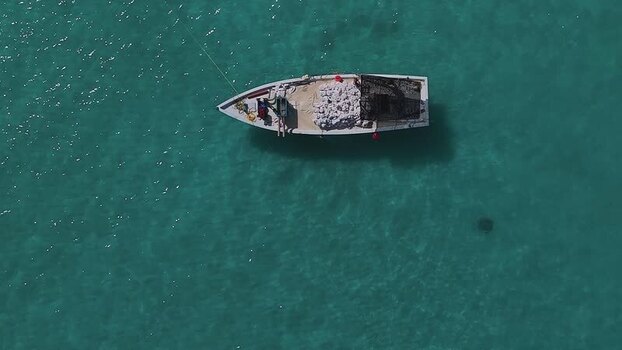 Aerial view of a small boat on turquoise water Maldives. Aerial view of a small boat on turquoise water Maldives.