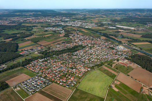 Aerial view of Hausen featuring red roofed houses nestled among fertile agricultural fields and dense forests Hausen Bavaria Germany.