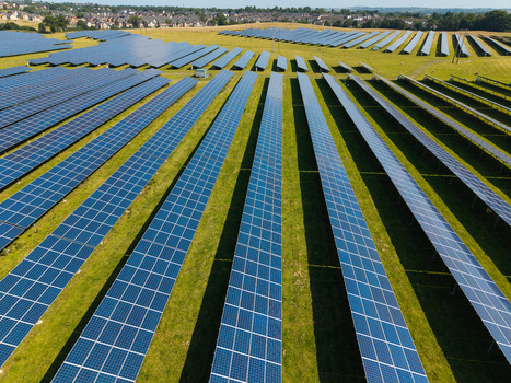 Aerial view of Lisburn Solar Farm featuring rows of photovoltaic panels installed on green fields in Lisburn Northern Ireland United Kingdom. Aerial view of Lisburn Solar Farm featuring rows of photovoltaic panels installed on green fields in Lisburn Northern Ireland United Kingdom.