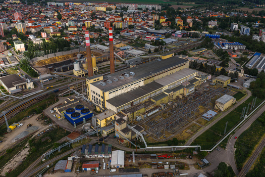 Aerial view of Tepelna elektrarna Hodonin power station with its tall striped chimneys and industrial buildings Hodonin Jihomoravsky kraj Czechia. Aerial view of Tepelna elektrarna Hodonin power station with its tall striped chimneys and industrial buildings Hodonin Jihomoravsky kraj Czechia.