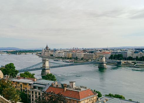 View of the Szechenyi Chain Bridge spanning the Danube River with the Hungarian Parliament Building in the background in Budapest Hungary. View of the Szechenyi Chain Bridge spanning the Danube River with the Hungarian Parliament Building in the background in Budapest Hungary.
