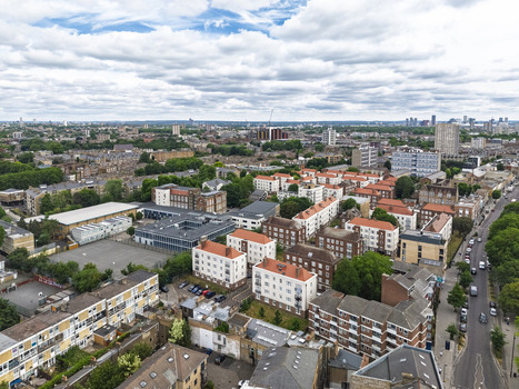 Aerial view of Shoreditch featuring residential apartment blocks urban streets and rooftops in London England United Kingdom. Aerial view of Shoreditch featuring residential apartment blocks urban streets and rooftops in London England United Kingdom.