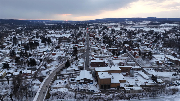 Aerial view of the town of Wrightsville covered in snow featuring residential rooftops a bridge over the river and industrial buildings in Wrightsville Pennsylvania United States. Aerial view of the town of Wrightsville covered in snow featuring residential rooftops a bridge over the river and industrial buildings in Wrightsville Pennsylvania United States.