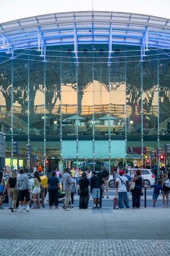 Lisboa Portugal 19 September 2026 View of Gare do Oriente with its glass and steel structure reflecting the sunset featuring a crowd of commuters and travelers in the foreground. Lisboa Portugal 19 September 2026 View of Gare do Oriente with its glass and steel structure reflecting the sunset featuring a crowd of commuters and travelers in the foreground.