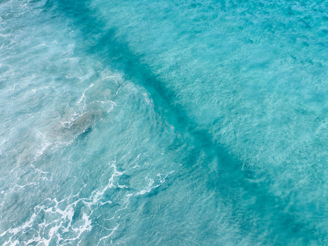 Aerial view of turquoise ocean waves with white sea foam in Lanzarote. Aerial view of turquoise ocean waves with white sea foam in Lanzarote.
