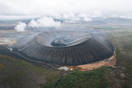 Aerial view of Hverfjall volcanic crater with its distinct circular rim and dark ash slopes under a cloudy sky in Thingeyjarsveit Iceland.