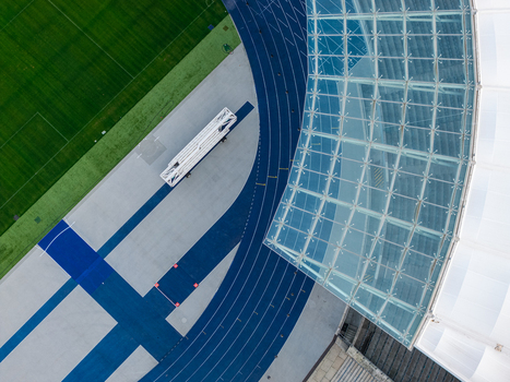 Berlin Berlin 26 September 2026 Aerial view of Olympiastadion Berlin showing the blue running track green grass field and the modern glass roof structure.