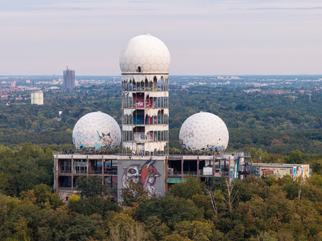 Aerial view of the abandoned Teufelsberg NSA Station with its iconic geodesic domes covered in graffiti set amidst the lush Grunewald forest in Berlin Berlin Germany.
