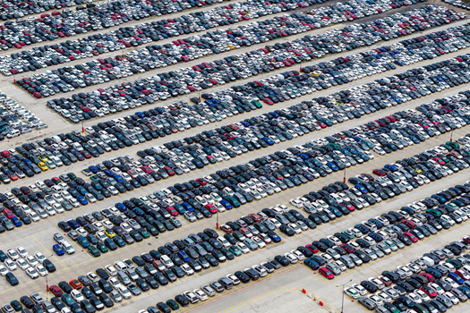 Aerial view of a large parking lot filled with numerous new cars at a car forwarding company in Poland.