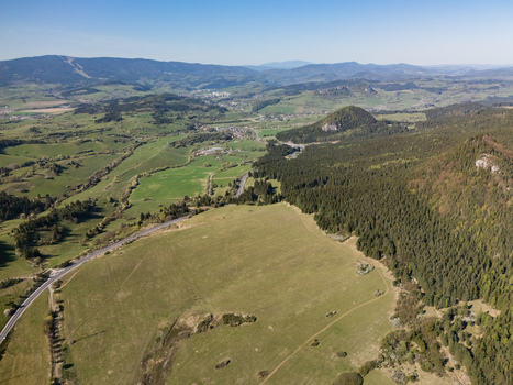 Aerial view of Valaska Dubova village surrounded by lush green hills dense forests and rolling mountains under a clear blue sky Valaska Dubova Zilina Region Slovakia. Aerial view of Valaska Dubova village surrounded by lush green hills dense forests and rolling mountains under a clear blue sky Valaska Dubova Zilina Region Slovakia.