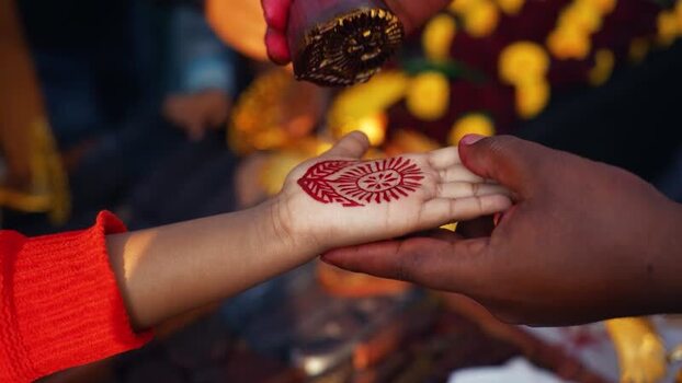 View of a traditional red stamp being applied to a hand Bangladesh. View of a traditional red stamp being applied to a hand Bangladesh.