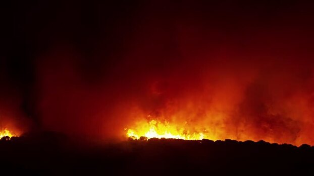 View of a forest fire burning at night in Spain.