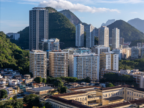 Aerial view of Botafogo neighborhood featuring high rise residential buildings nestled against lush green mountains under a clear sky Rio de Janeiro Rio de Janeiro Brazil.