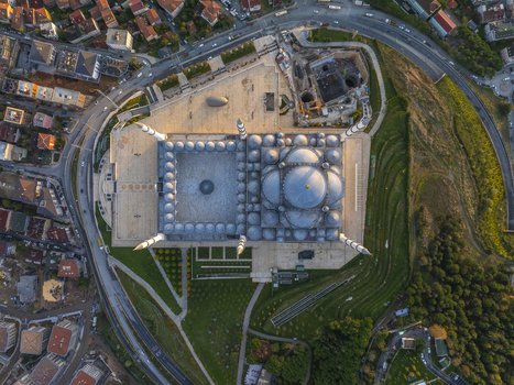 Aerial view of the Grand Camlica Mosque with its large central dome multiple smaller domes and slender minarets surrounded by gardens and urban roads in Uskudar Istanbul Turkiye. Aerial view of the Grand Camlica Mosque with its large central dome multiple smaller domes and slender minarets surrounded by gardens and urban roads in Uskudar Istanbul Turkiye.