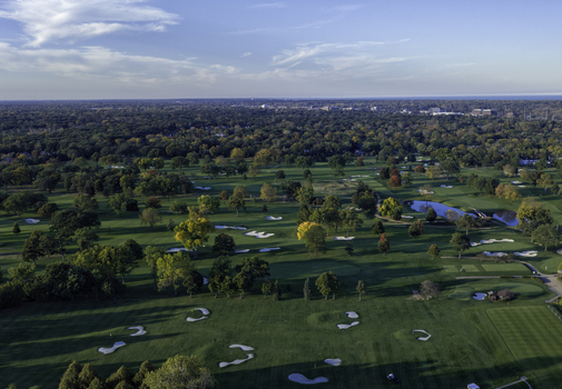 Aerial view of a golf course in autumn with vibrant fall foliage sand bunkers and a small pond in Glenview Illinois United States. Aerial view of a golf course in autumn with vibrant fall foliage sand bunkers and a small pond in Glenview Illinois United States.