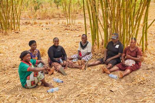 Kundu Federal Capital Terri Nigeria 19 September 2026 View of women resting on the ground at SCL Agroindustrial Farm surrounded by dry grass and bamboo stalks. Kundu Federal Capital Terri Nigeria 19 September 2026 View of women resting on the ground at SCL Agroindustrial Farm surrounded by dry grass and bamboo stalks.