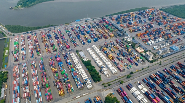 Aerial view of Jawaharlal Nehru Port Authority with rows of colorful shipping containers and industrial gantry cranes in Juna Sheva Maharashtra India. Aerial view of Jawaharlal Nehru Port Authority with rows of colorful shipping containers and industrial gantry cranes in Juna Sheva Maharashtra India.