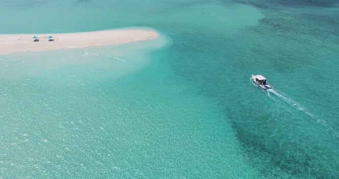 Aerial view of a boat cruising near a sandbar in Dhidhdhoo Maldives. Aerial view of a boat cruising near a sandbar in Dhidhdhoo Maldives.
