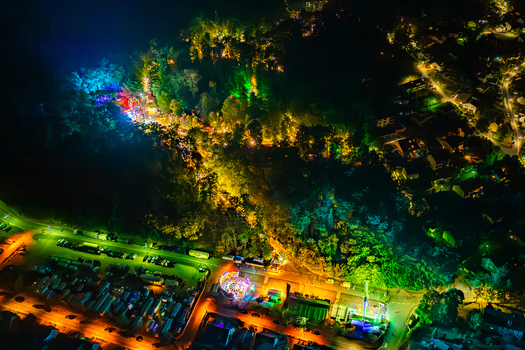 Aerial view of the Annafest folk festival at night with colorful lights illuminating the forest and fairground rides in Forchheim Bayern Germany. Aerial view of the Annafest folk festival at night with colorful lights illuminating the forest and fairground rides in Forchheim Bayern Germany.