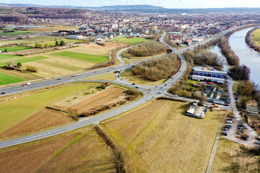 Aerial view of the town of Buttenheim featuring the Regnitz river highway junctions and sprawling agricultural fields under a clear sky in Buttenheim Bavaria Germany. Aerial view of the town of Buttenheim featuring the Regnitz river highway junctions and sprawling agricultural fields under a clear sky in Buttenheim Bavaria Germany.