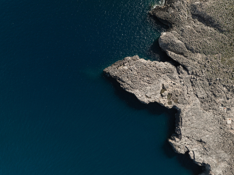 Aerial view of jagged limestone cliffs and deep blue Mediterranean sea in Plemmirio Sicily Italy. Aerial view of jagged limestone cliffs and deep blue Mediterranean sea in Plemmirio Sicily Italy.