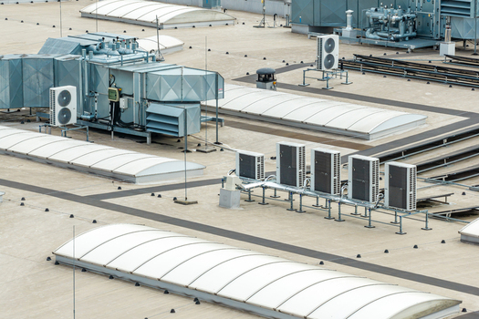 Aerial view of industrial warehouse roof with advanced HVAC systems and sustainable skylights in Warszawa Wojewodztwo mazowieckie Poland. Aerial view of industrial warehouse roof with advanced HVAC systems and sustainable skylights in Warszawa Wojewodztwo mazowieckie Poland.
