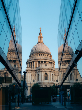 London United Kingdom 21 June 2025 View of St. Paul s Cathedral its dome piercing the sky framed by modern glass buildings reflecting the soft light of the evening sun. London United Kingdom 21 June 2025 View of St. Paul s Cathedral its dome piercing the sky framed by modern glass buildings reflecting the soft light of the evening sun.